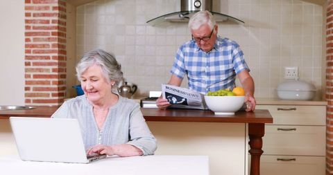 Elderly Couple Enjoying Leisure Time in Kitchen - Download Free Stock Images Pikwizard.com