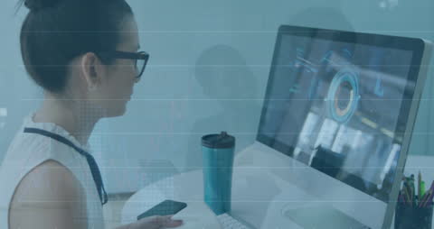 Businesswoman Analyzing Financial Data on Computer with Graph Overlay