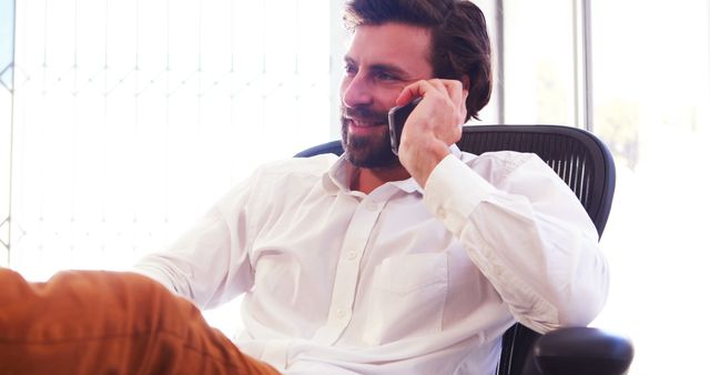 Confident Professional Man Talking on Phone in Office - Download Free Stock Images Pikwizard.com