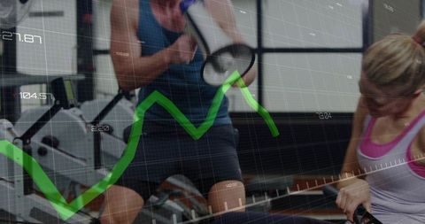Fitness instructor coaching indoor rowing class with megaphone and analytics overlay