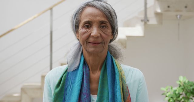 Elderly Woman with Gray Hair Smiling Indoors with Colorful Scarf - Download Free Stock Images Pikwizard.com