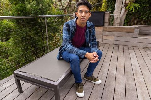 Young Man Relaxing on Wooden Deck with Stylish Exterior Design