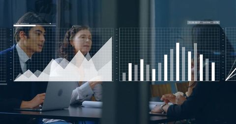 Team Analyzing Digital Charts in Modern Conference Room