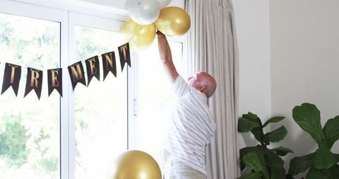 Senior man decorating for joyful retirement celebration