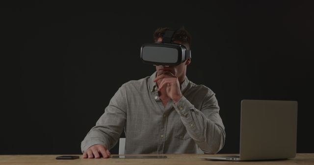 Man Using VR Headset with Laptop at Desk - Download Free Stock Images Pikwizard.com