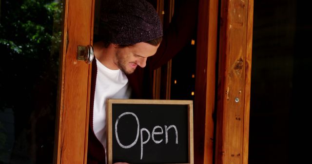 Cafe Owner Holding Open Sign at Door - Download Free Stock Images Pikwizard.com