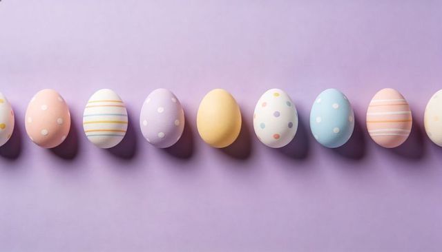 Pastel easter eggs lined on lavender backdrop minimal flatlay with stripes and polka dots