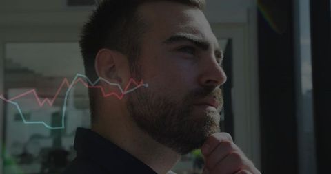 Contemplative businessman opposite data trends exploration