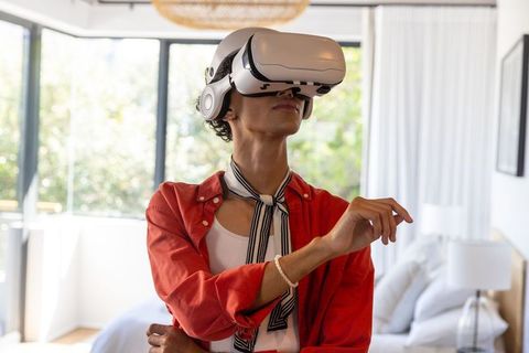 Man Using Virtual Reality Headset in Modern Bedroom