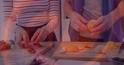 Friends Preparing Fresh Fruit in Cozy Kitchen Setting