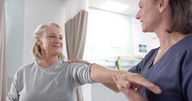 Senior Woman Undergoing Arm Physical Therapy with Healthcare Professional - Download Free Stock Images Pikwizard.com