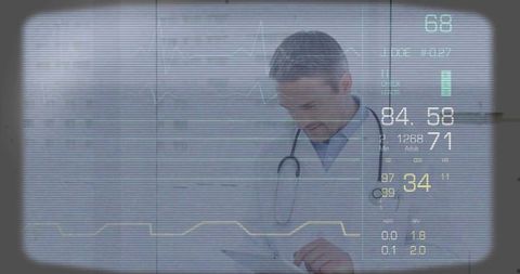Examining physician checking tablet with ecg overlay and digital vital signs monitor