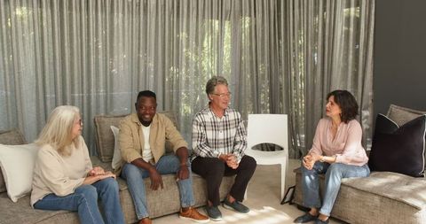 Diverse group therapy participants engaging in a conversation