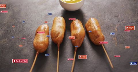 Golden fried corn dogs on sticks over dark slate with mustard and social media badges