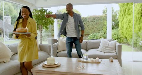 Joyful gathering with cake and refreshments in bright living room