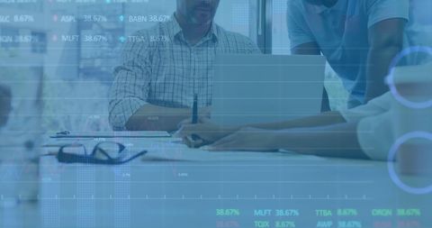 Diverse business team analyzing financial data using laptop
