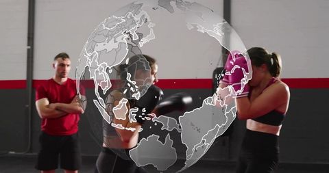 Female boxing sparring session in gym with coach and translucent globe overlay, pink gloves