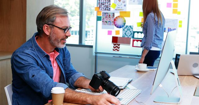 Graphic Designer Editing Photos at Office Desk - Download Free Stock Images Pikwizard.com