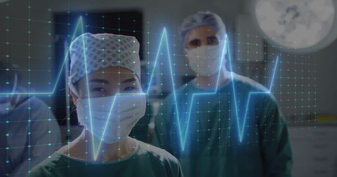 Healthcare Professionals Observing Virtual Cardiogram in Hospital
