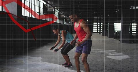 Partners doing warehouse hiit workout wearing athletic gear with red line graph overlay