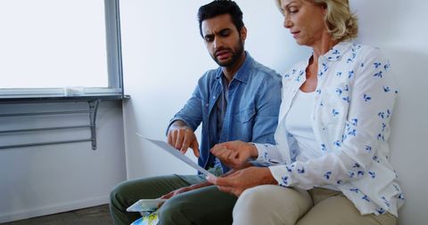 Diverse colleagues reviewing documents in modern workspace
