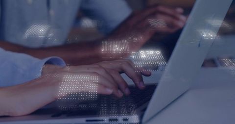 Hands Typing on Laptops with Futuristic Digital Overlay