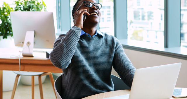 Middle-Aged Businessman Smiling During Phone Call at Office Desk - Download Free Stock Images Pikwizard.com