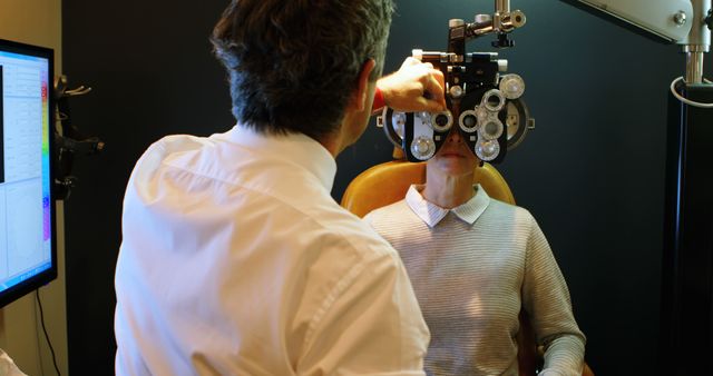 Optician Examining Patient with Phoropter in Modern Clinic - Download Free Stock Images Pikwizard.com