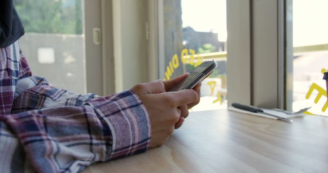 Person Texting on Smartphone at Modern Cafe Interior - Download Free Stock Images Pikwizard.com