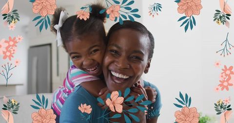 Joyful African American Mother and Daughter with Floral Design