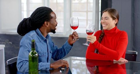 Couple Enjoying Red Wine in Bright Modern Living Room Setting