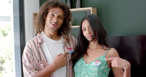 Couple proudly displaying i voted stickers for civic engagement