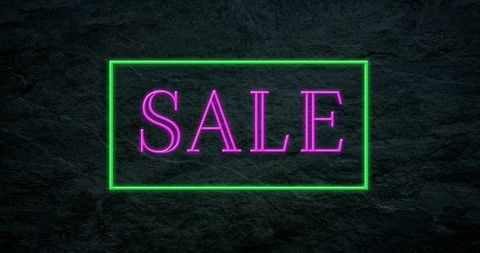Neon Pink Sale Sign with Green Border on Dark Background