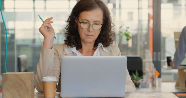 Focused Mature Woman Working on Laptop in Modern Office - Download Free Stock Images Pikwizard.com