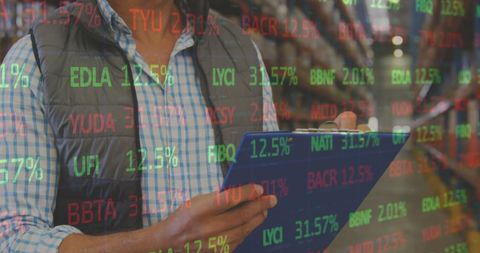 Inventory Specialist Analyzing Stock Market Data in Warehouse