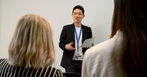 Asian Businessman Presenting During Professional Meeting with Copy Space