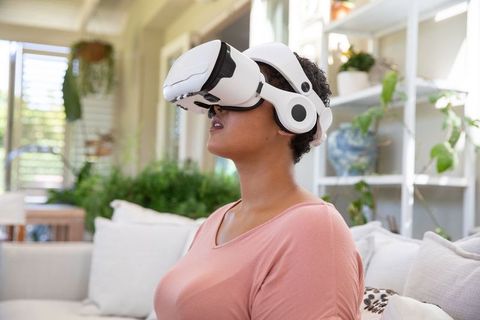Woman Relaxing at Home with Virtual Reality Headset
