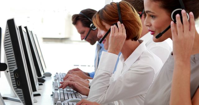 Customer Service Team Using Headsets and Computers in Modern Office - Download Free Stock Images Pikwizard.com