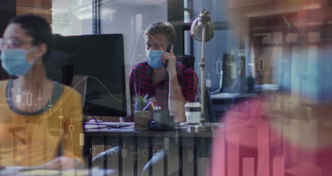 Man in Office Analyzing Statistical Data on Screen
