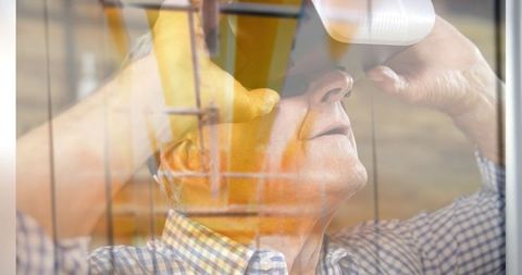 Senior Man Experiencing Virtual Reality with Servers Overlay