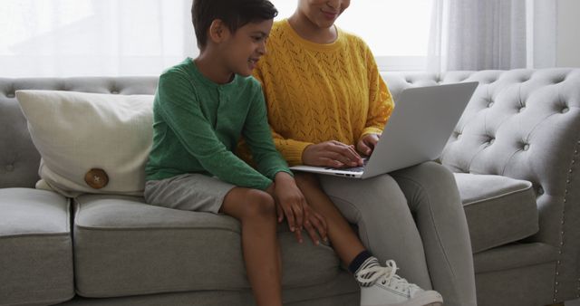 Mother and Son Using Laptop on Sofa at Home - Download Free Stock Images Pikwizard.com