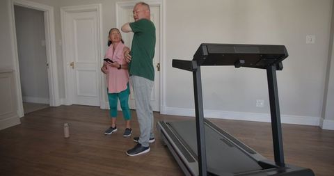 Senior couple embracing home workout and health technology