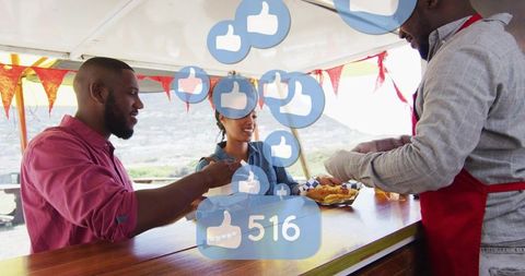 Couple enjoying seaside street food at kiosk with social media likes overlay