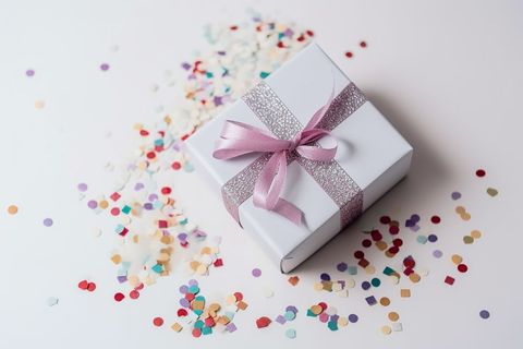 Elegant Gift Box with Confetti on White Background