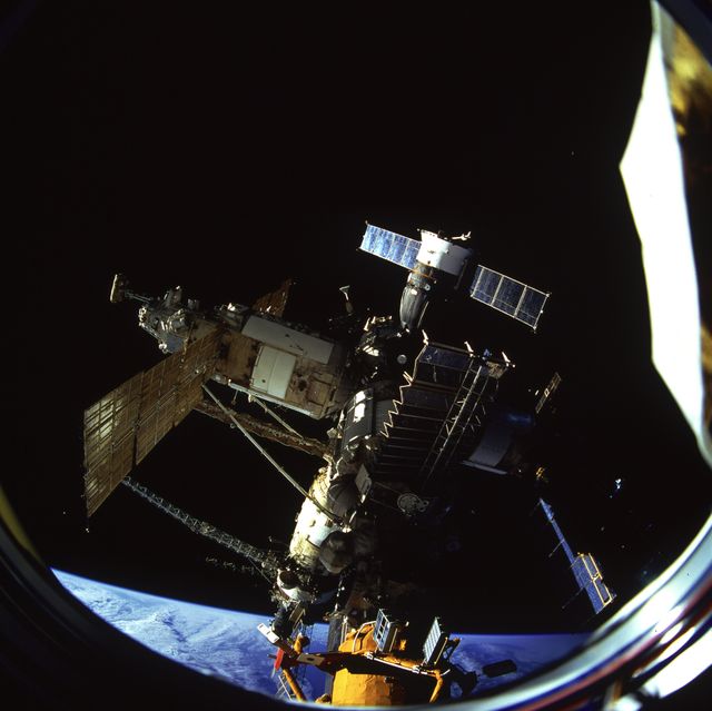 STS079-813-023 (16-26 Sept. 1996) --- The docked Russian Mir Space Station is partially visible through the Spacehab viewing port, onboard the space shuttle Atlantis. This photograph is one of four 70mm frames (along with fifteen 35mm frames) of still photography documenting the activities of NASA's STS-79 mission, which began with a Sept. 16, 1996, liftoff from Launch Pad 39A the Kennedy Space Center (KSC) and ended with a landing at KSC on Sept. 26, 1996. Onboard for the launch were astronauts William F. Readdy, commander; Terrence W. Wilcutt, pilot; John E. Blaha, Jerome (Jay) Apt, Thomas D. Akers and Carl E. Walz, all mission specialists.  On flight day 4, the crew docked with the Mir Space Station.  Shannon W. Lucid, who had spent six months aboard Mir, switched cosmonaut guest researcher roles with Blaha.  The latter joined fellow Mir-22 crewmembers Valeri G. Korzun, commander, and Aleksandr Y. Kaleri, flight engineer.