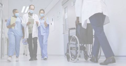 Medical Team Collaborating in Hospital Hallway with Technology