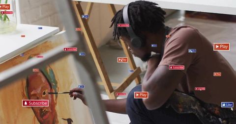 Artist immersed in painting with digital multimedia elements