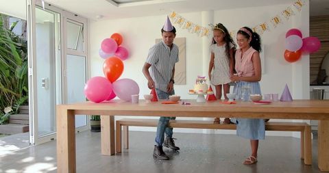 Parents with Daughter Celebrating Birthday at Home
