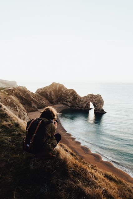 Photographer Capturing Coastal Rock Formation at Sunset - Download Free Stock Images Pikwizard.com