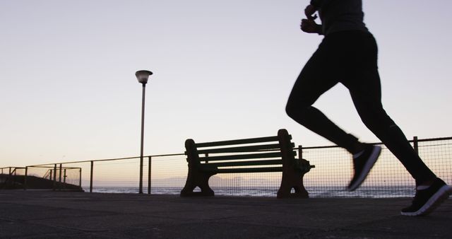 African american man exercising outdoors, running by seaside in the evening - Download Free Stock Photos Pikwizard.com